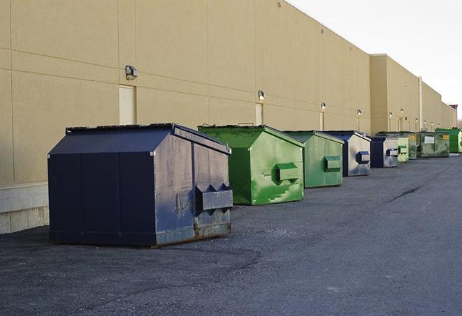 a series of colorful, utilitarian dumpsters deployed in a construction site in Amston, CT